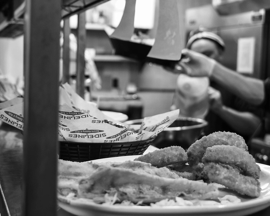 Back of house cooks with order at Sidelines